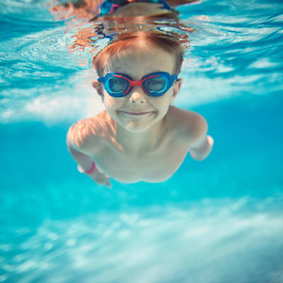 Child swimming in the pool at Ogilvie Hardware Lofts in Shreveport, Louisiana