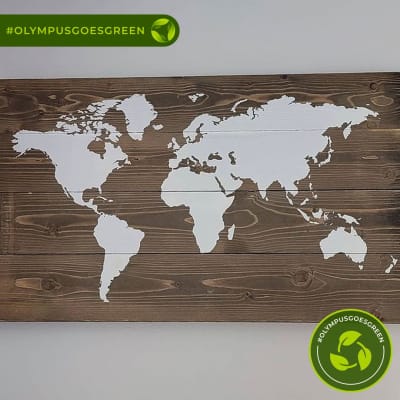 Map of the world painted in white on recycled wood 