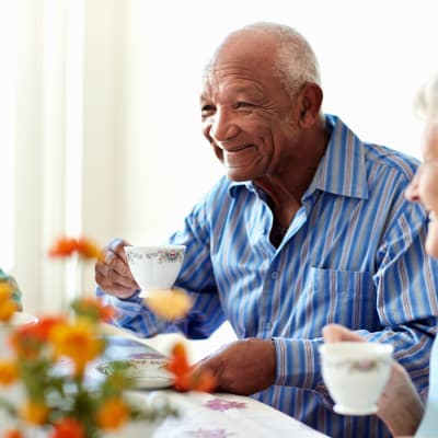 Resident man drinking coffee at Arbor Glen Senior Living in Lake Elmo, Minnesota