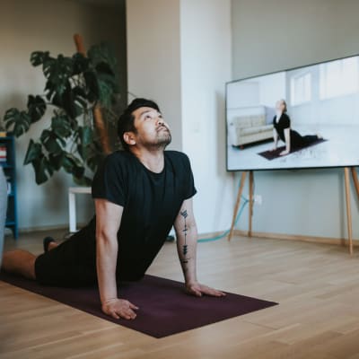 Resident doing yoga in his living room at Marq 31 in Houston, Texas