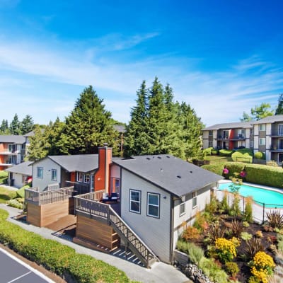 Overhead shot of buildings, trees, and a community pool at Haven Apartment Homes in Kent, Washington