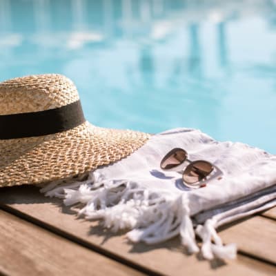 a hat and sunglasses by the pool at Copper Canyon in Twentynine Palms, California