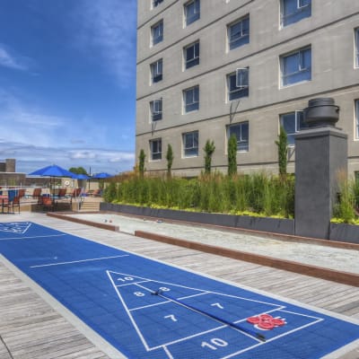 Shuffleboard courts on an outdoor deck on a sunny day at Panorama Apartments in Seattle, Washington