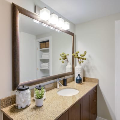 Clean bathroom with huge mirror over the vanity at Sofi 55 Hundred in Arlington, Virginia