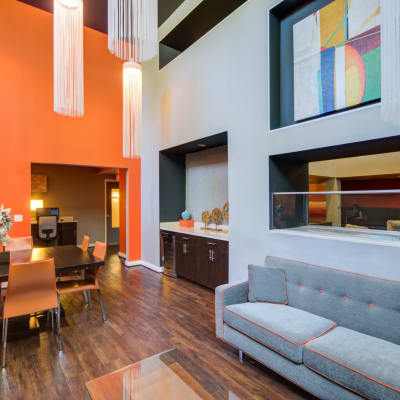 Resident lounge with a nice large couch and wood style flooring at Sofi 55 Hundred in Arlington, Virginia