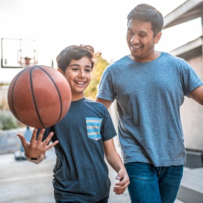 a father and son playing basketball at Pecan Crescent in Chesapeake, Virginia