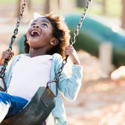 a young girl on a swing set at South Mesa I in Oceanside, California