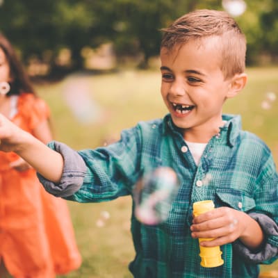 a child playing with bubbles at Sea Breeze Village in Seal Beach, California