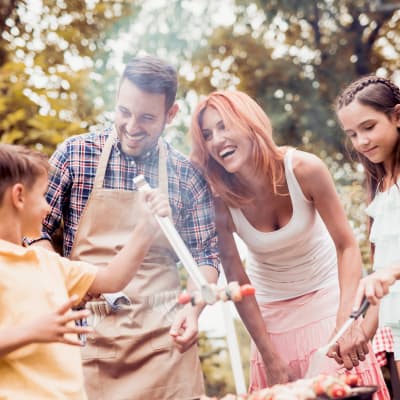 a resident family enjoying a bbq together at Howard Gilmore Terrace in La Mesa, California