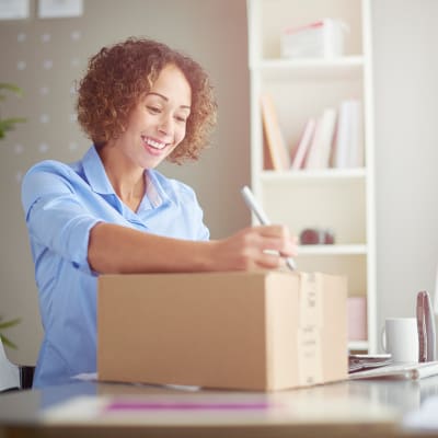 a woman unpacking a box at Sandpiper Crescent in Virginia Beach, Virginia