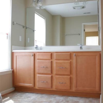 a bathroom with plenty of cabinetry at The Village at New Gosport in Portsmouth, Virginia