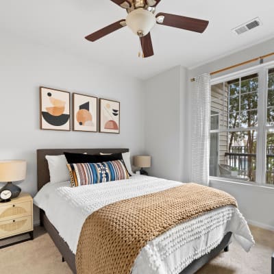 Well lit bedroom with a ceiling fan to keep you cool at Sofi Lyndhurst in Lyndhurst, New Jersey