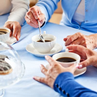 Residents drinking coffee at Willows Bend Senior Living in Fridley, Minnesota