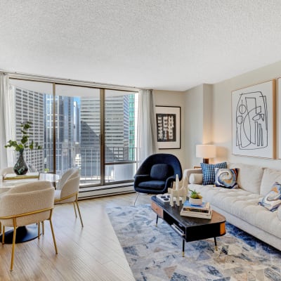 Well-decorated and spacious living space with floor-to-ceiling windows in a model home at Tower 801 in Seattle, Washington