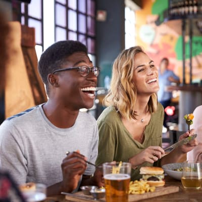 Friends out at their favorite restaurant grabbing food and drinks near Main Street Apartments in Rockville, Maryland