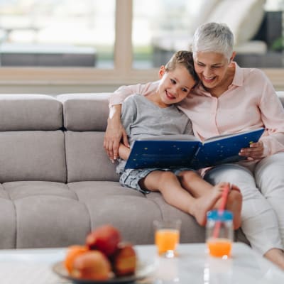 Resident reading with her grandchild at Mariposa at Jason Avenue in Amarillo, Texas