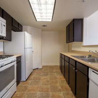 A resident cooking in her kitchen at Two Mile in Twentynine Palms, California