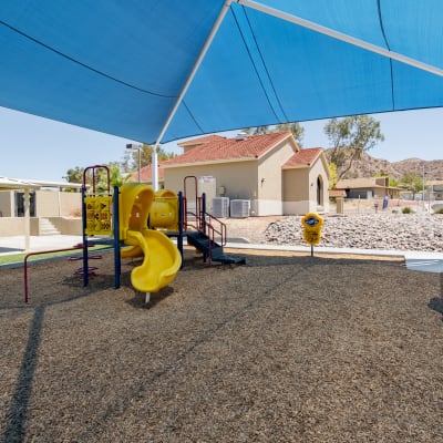 Resident pushing his children on the swings at Two Mile in Twentynine Palms, California