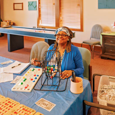 Resident at Bingo Night showing off a photo of her family at Peoples Senior Living in Tacoma, Washington
