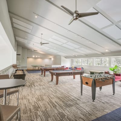 Resident game room/lounge with multiple pool tables and foosball at The Villas at Woodland Hills in Woodland Hills, California