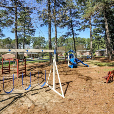 A swing set in the on-site playground at Rivers Edge Apartments in Jonesboro, Georgia