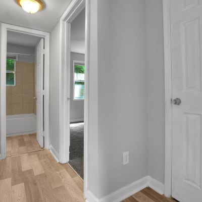 Wood flooring in an apartment hallway leading to the bedroom and bathroom at Stanton View Apartments in Atlanta, Georgia