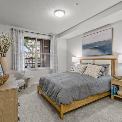 Model bedroom with carpet and large windows at The Jones in Hillsboro, Oregon