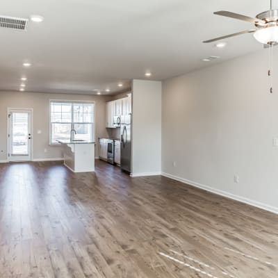 A spacious apartment home living room with wood flooring at Rows at Pinestone in Travelers Rest, South Carolina