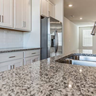 A granite countertop in an apartment kitchen at Rows at Pinestone in Travelers Rest, South Carolina