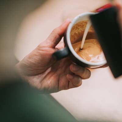 Hand with a coffee cup  Lyford Apartments in Tiburon, California