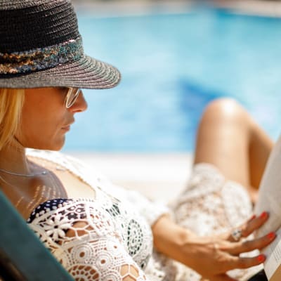 Woman reading by pool at Sheffield Square in Grand Prairie, Texas