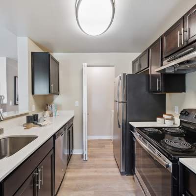 Modern kitchen with stainless-steel appliances in a model home at Madison Sammamish Apartments in Sammamish, Washington