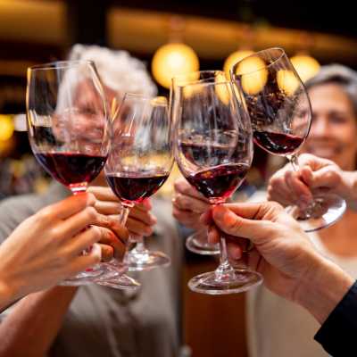 Residents cheersing with glasses of wine at a bar near The Standard at Pinestone in Travelers Rest, South Carolina