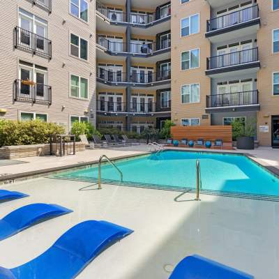 Community pool with lounge chairs at The Dartmouth North Hills in Raleigh, North Carolina