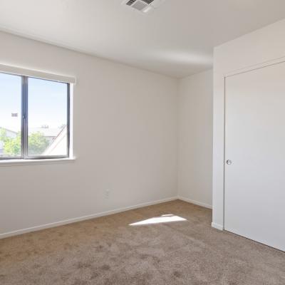 A well-lit bedroom at Miramar Townhomes in San Diego, California