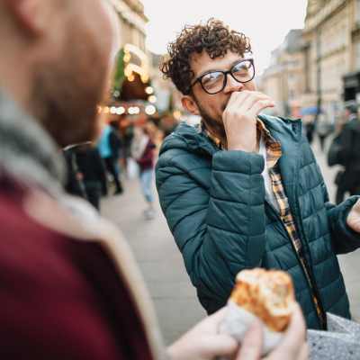 Resident and his friend eating burger near The Cameron in Portland, Oregon