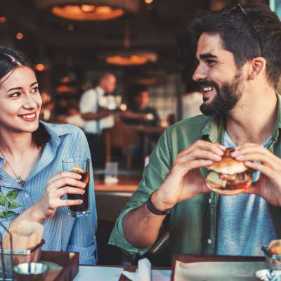 Resident couple having burger from restaurant near Palm Beach Preserve in West Palm Beach, Florida 