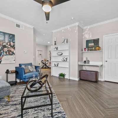 Spacious living room with herringbone wood inspired flooring at Station 3700 in Euless, Texas