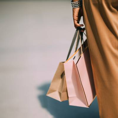 Resident carrying shopping bags near Exhibit On Superior in Chicago, Illinois