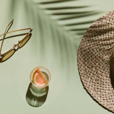 Refreshing drink, sunglasses, and a beach hat at Imperial 41 in Bonita Springs, Florida