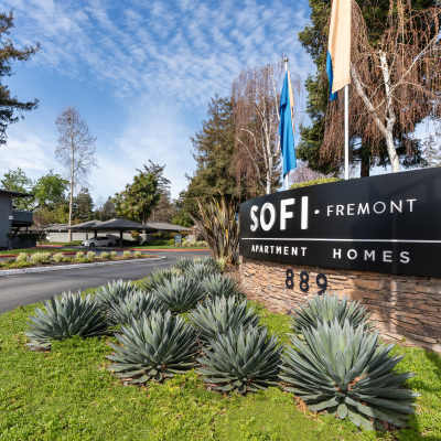 Our sign surrounded by flowers at the entrance to Sofi Fremont in Fremont, California