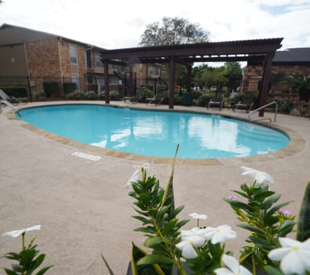A swimming pool that is great for entertaining at Newport Oaks Apartments in Alvin, Texas