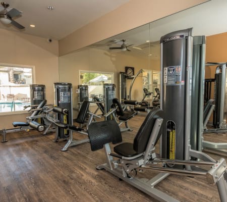 Fitness center with individual workout stations at Shadow Ridge Apartment Homes in Simi Valley, California