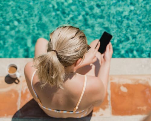 Resident on her phone poolside at Avion Point Apartments in Charlotte, North Carolina