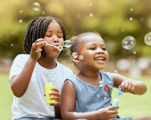 Resident children blowing bubbles outside at South Meadows in Rome, Georgia
