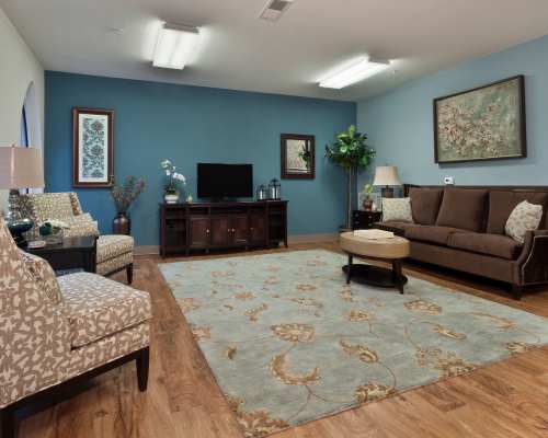 Clubhouse sitting room with a television for residents at Loftin I in Belmont, North Carolina