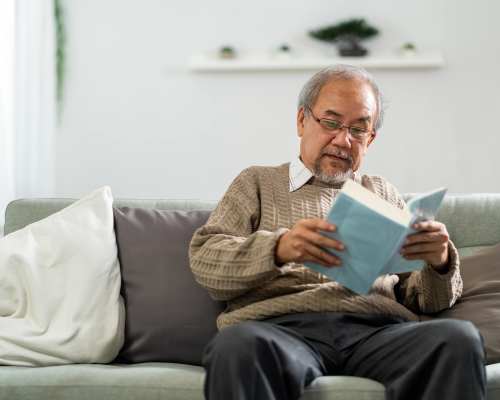 Resident reading a book at home Creekside at Adamsville Place in Atlanta, Georgia
