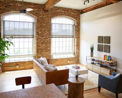 View of an living room with bright windows at Revolution Mill in Greensboro, North Carolina