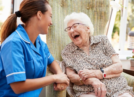 Staff nurse and resident share a joke at Westminster Memory Care in Aiken, South Carolina