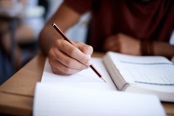 Person writing on paper